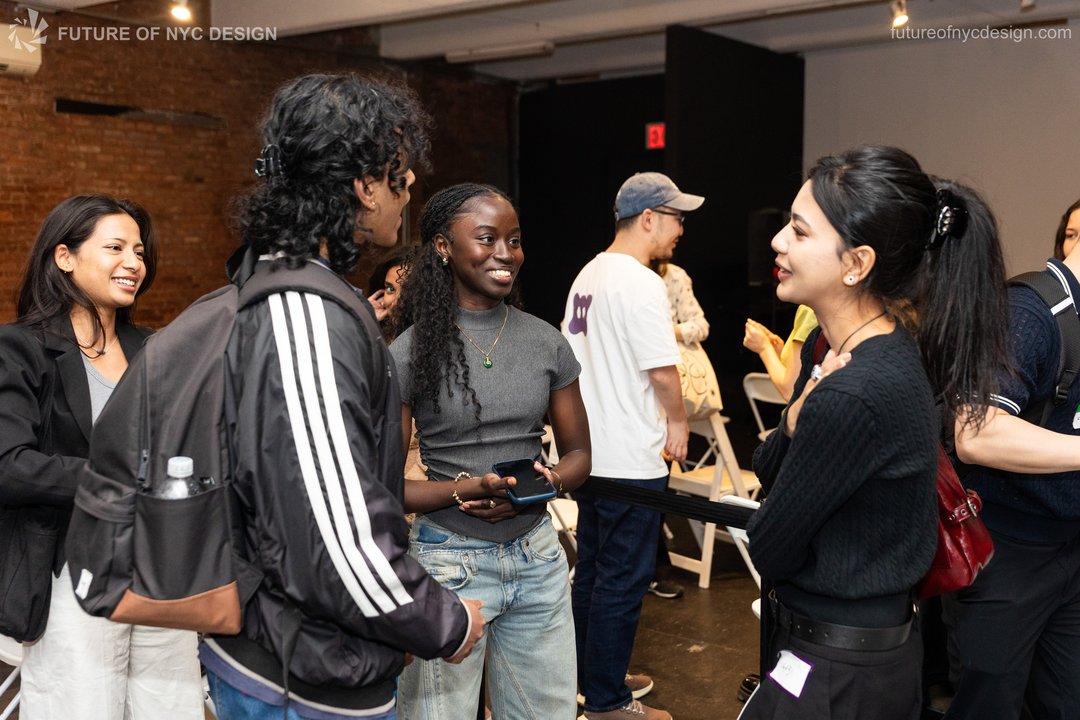 Attendees in conversation in the brick-walled venue during break