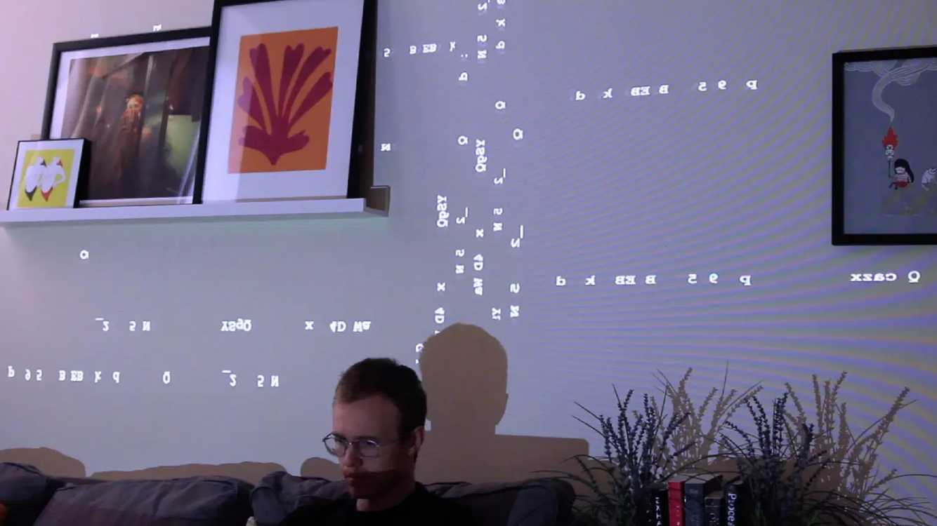 All Connecting video sculpture projecting network-inspired text through a room